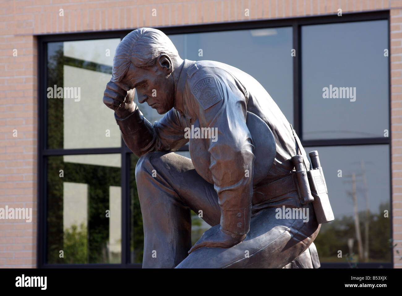 A bronze statue of a Milwaukee County Sheriff kneeling Wisconsin Stock