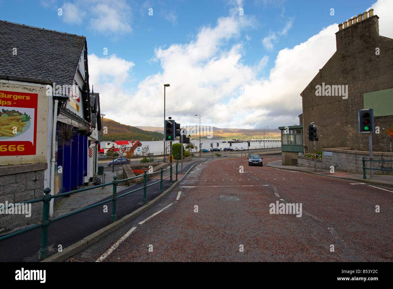 Car driving along road passing a green light in Fort William Scotland