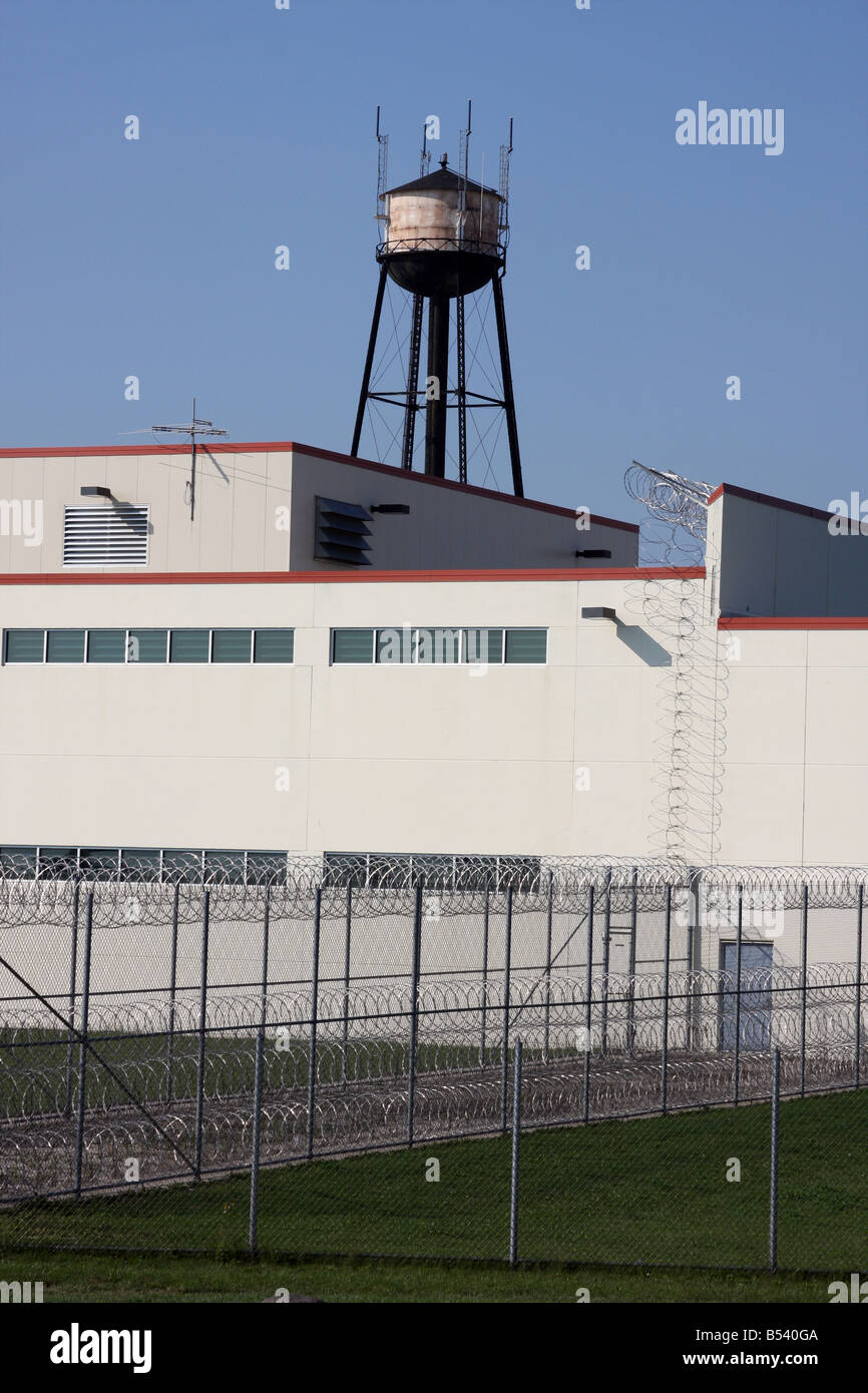 A prison barrier fence and water tower Stock Photo