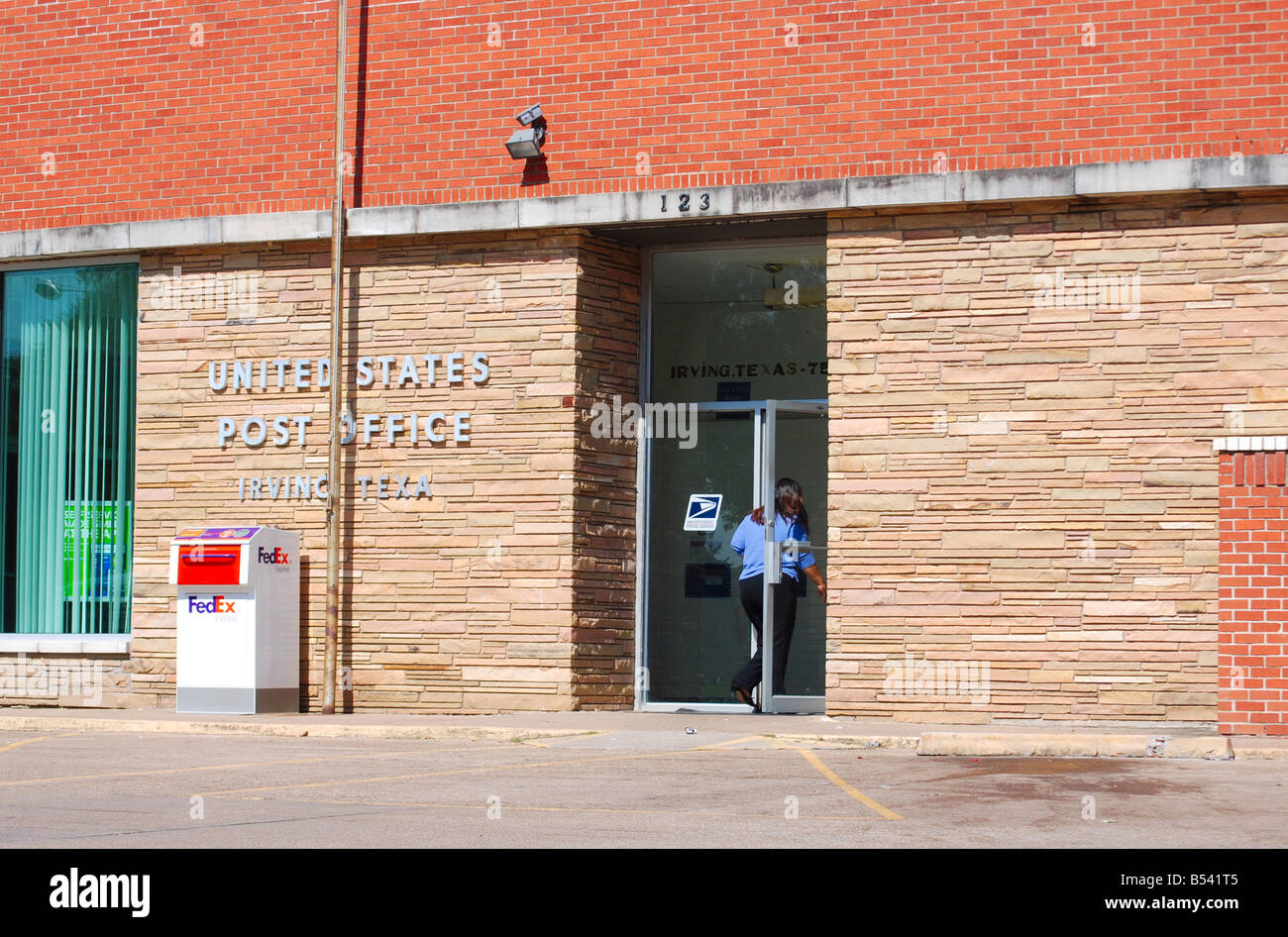 Woman walking into a United States post office Stock Photo