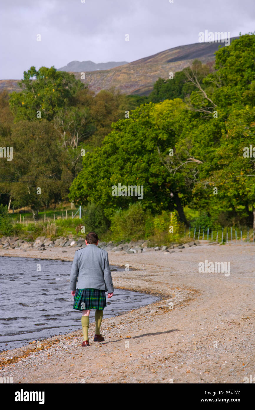 SCOTSMAN IN KILT BRAVING THE OCTOBER WEATHER AT LOCH LOMOND Stock Photo