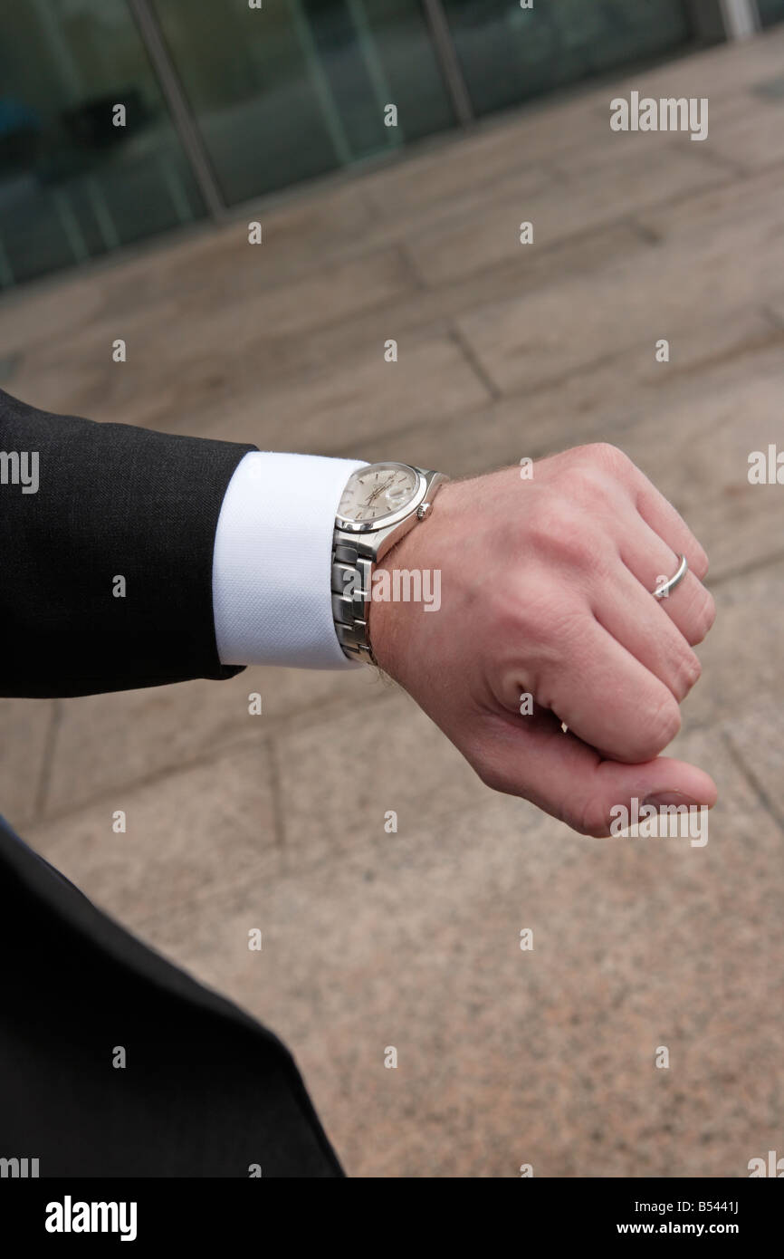 Businessman checking time on watch Stock Photo