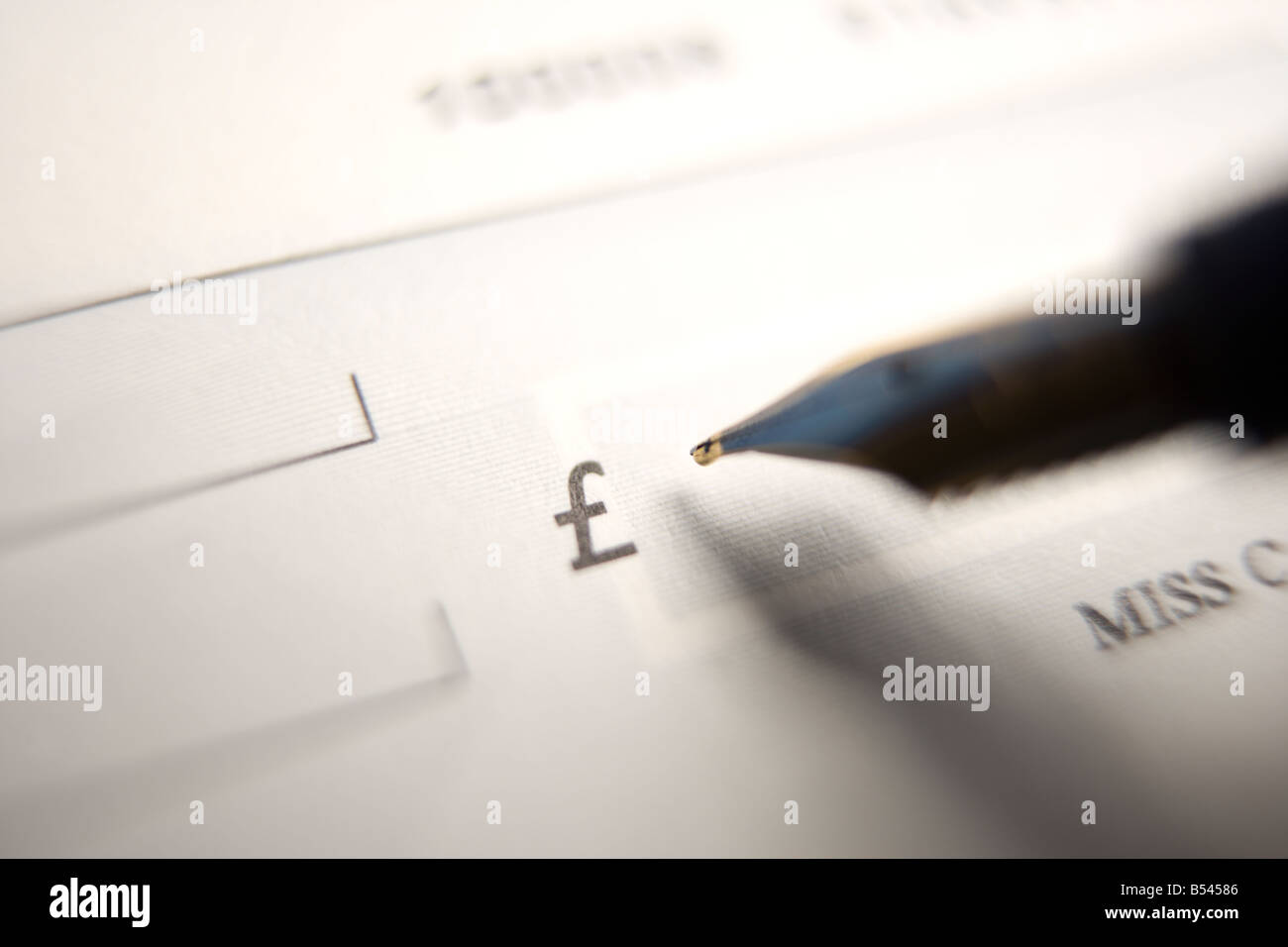 Close up of a pen and cheque. Writing a cheque Stock Photo Alamy