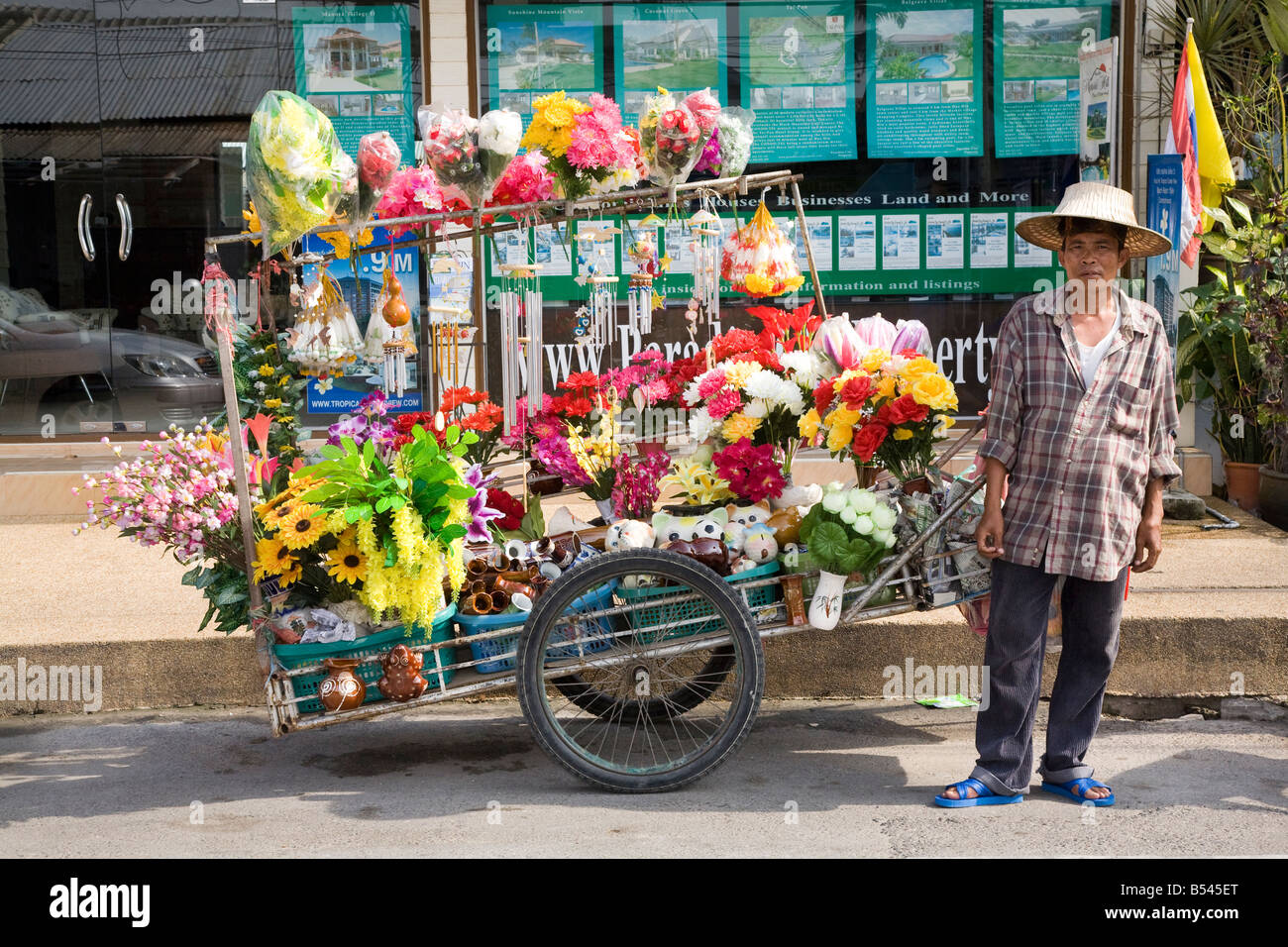 Asian male Flower Seller. Florist with flower cart in Hua Hin City