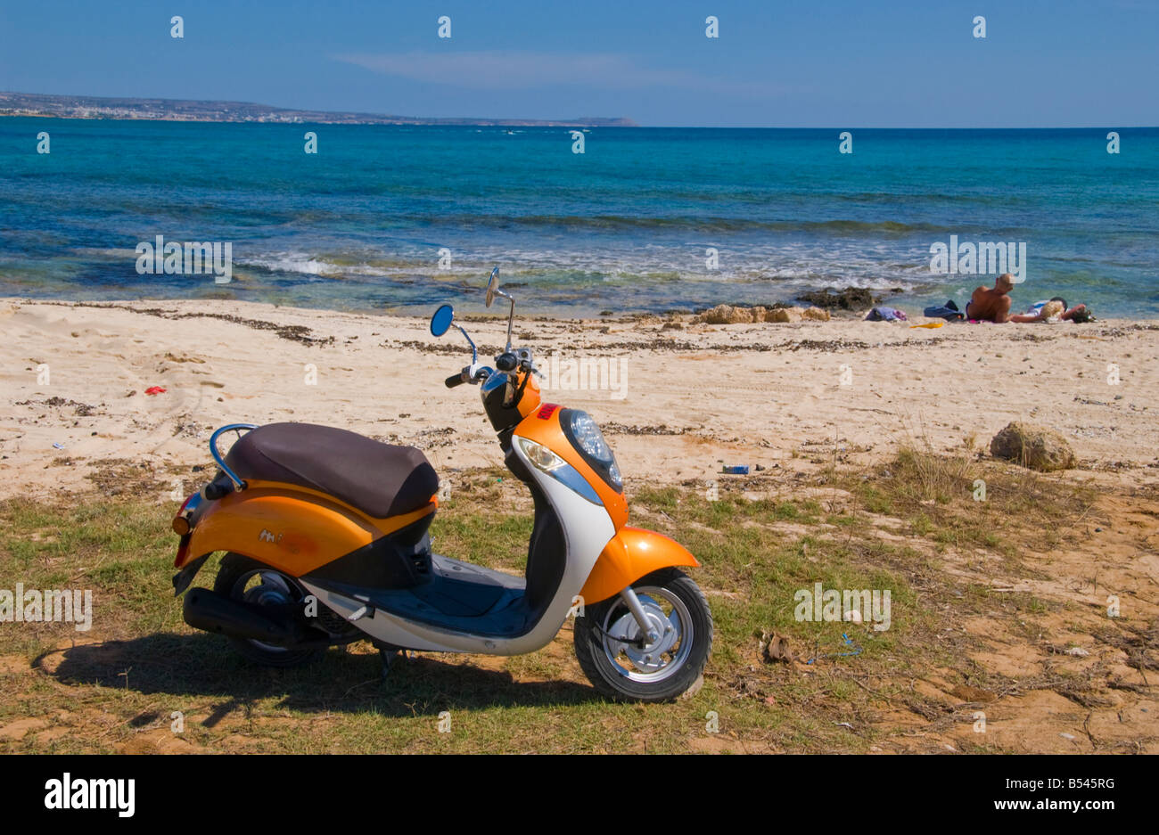 Cyprus beach. Tourist hire scooter parked on beach near Ayia Napa on