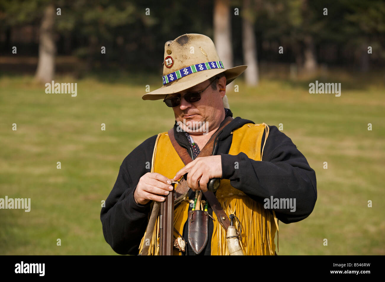 Man wearing trapper costume demonstrating black powder rifle at Steam Engine Show at Westwold, "British Columbia", Canada Stock Photo