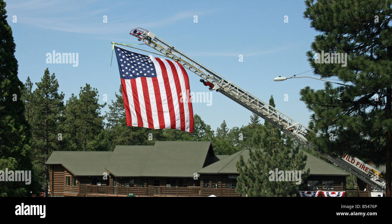The American Flag hangs from a fire engine ladder at the 4th of July