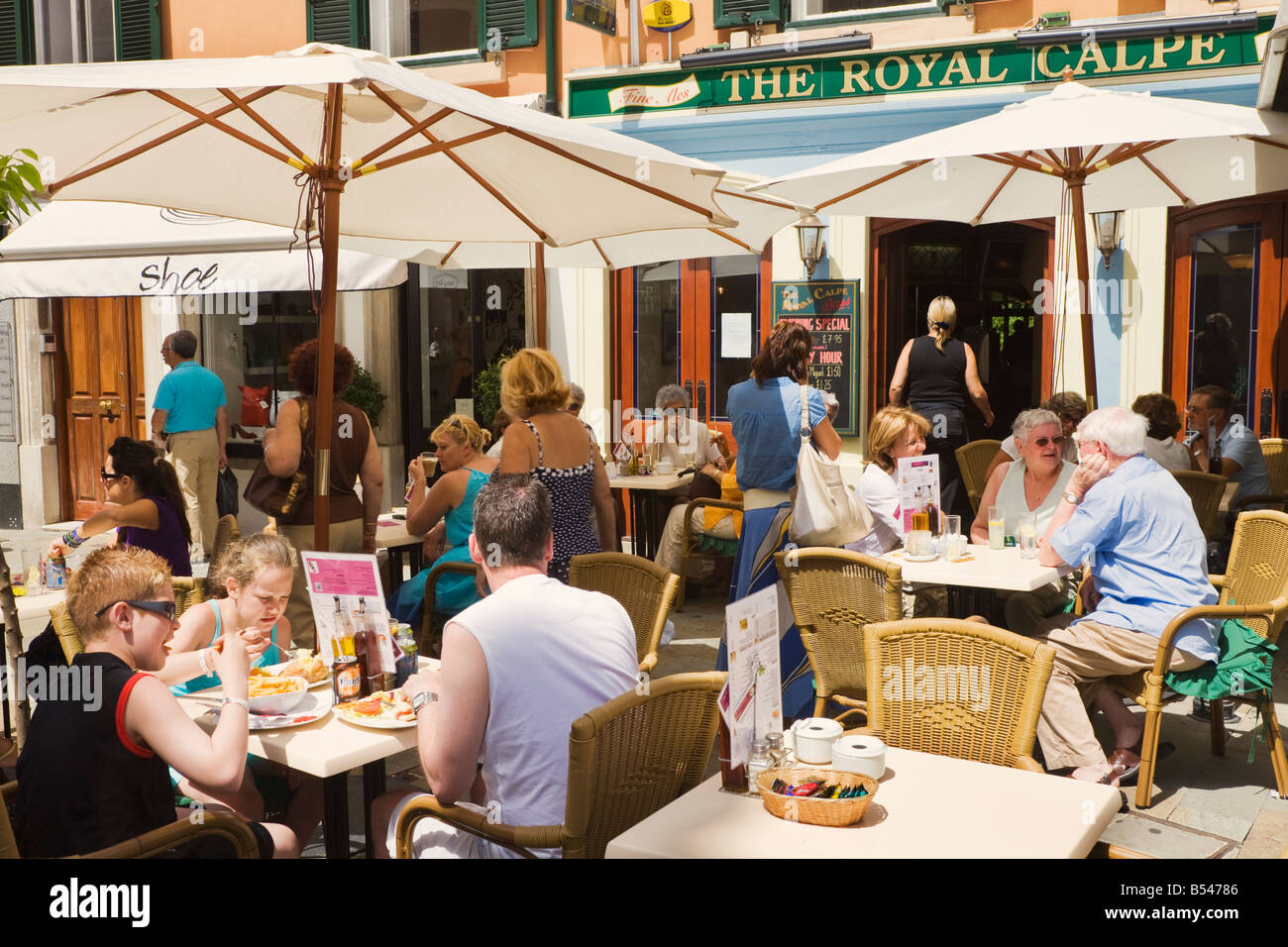 Gibraltar Diners at tables on street outside The Royal Calpe pub Stock Photo
