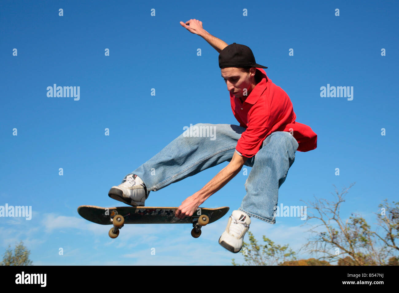 young man jumping with his skateboard Stock Photo