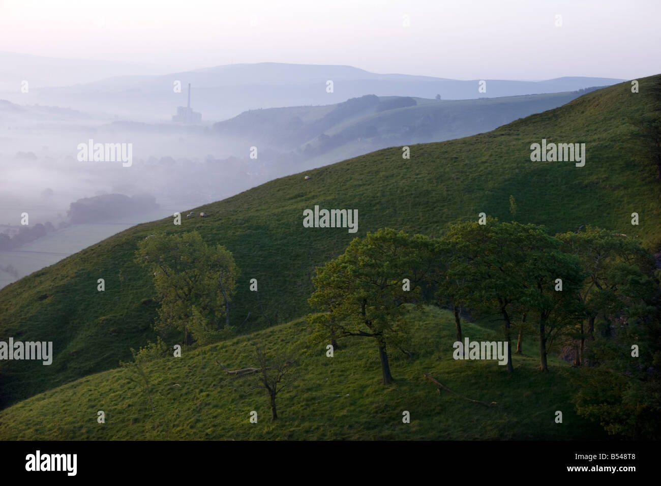 early morning misty landscape from the bottom of mam tor looking over the valley towards castleton Stock Photo