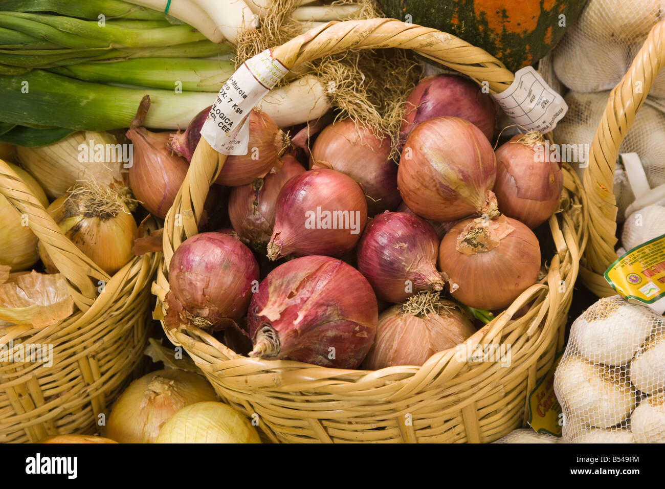 Basket of ecologically grown onions in health food shop Stock Photo