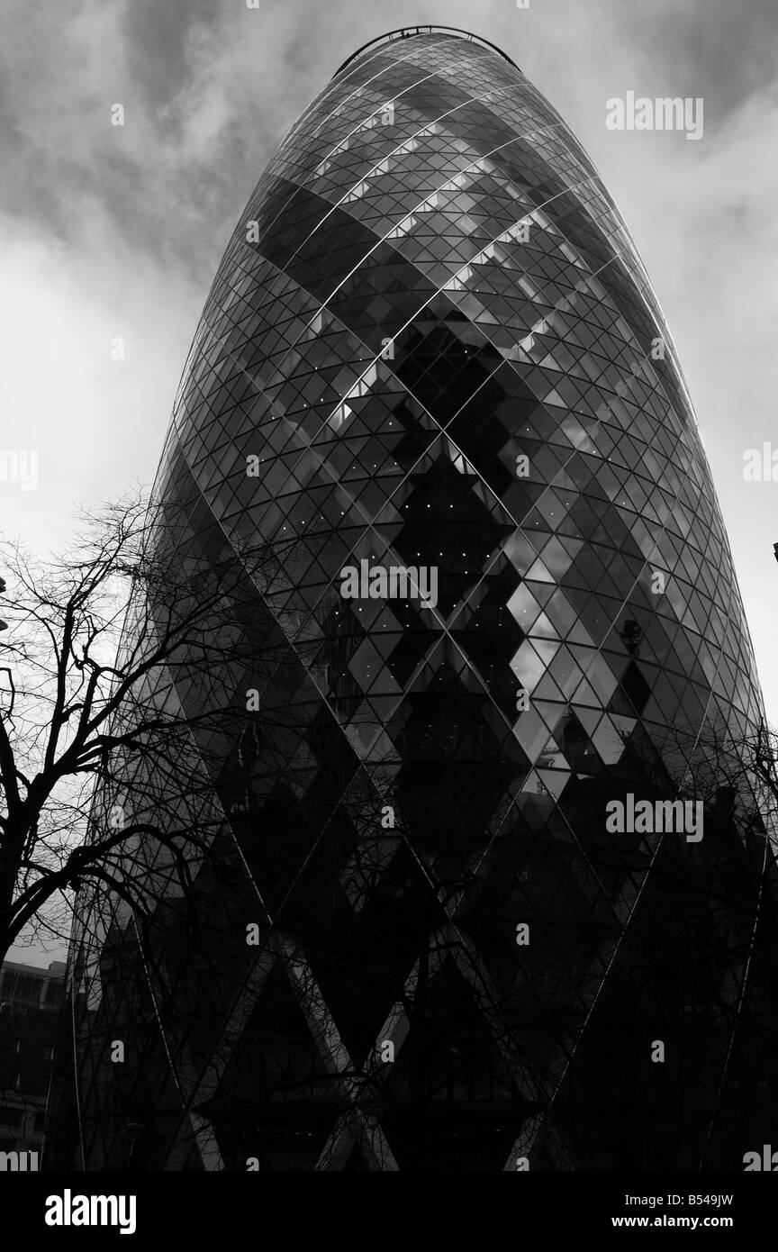 The Gherkin skyscraper in London England with dramatic looking sky