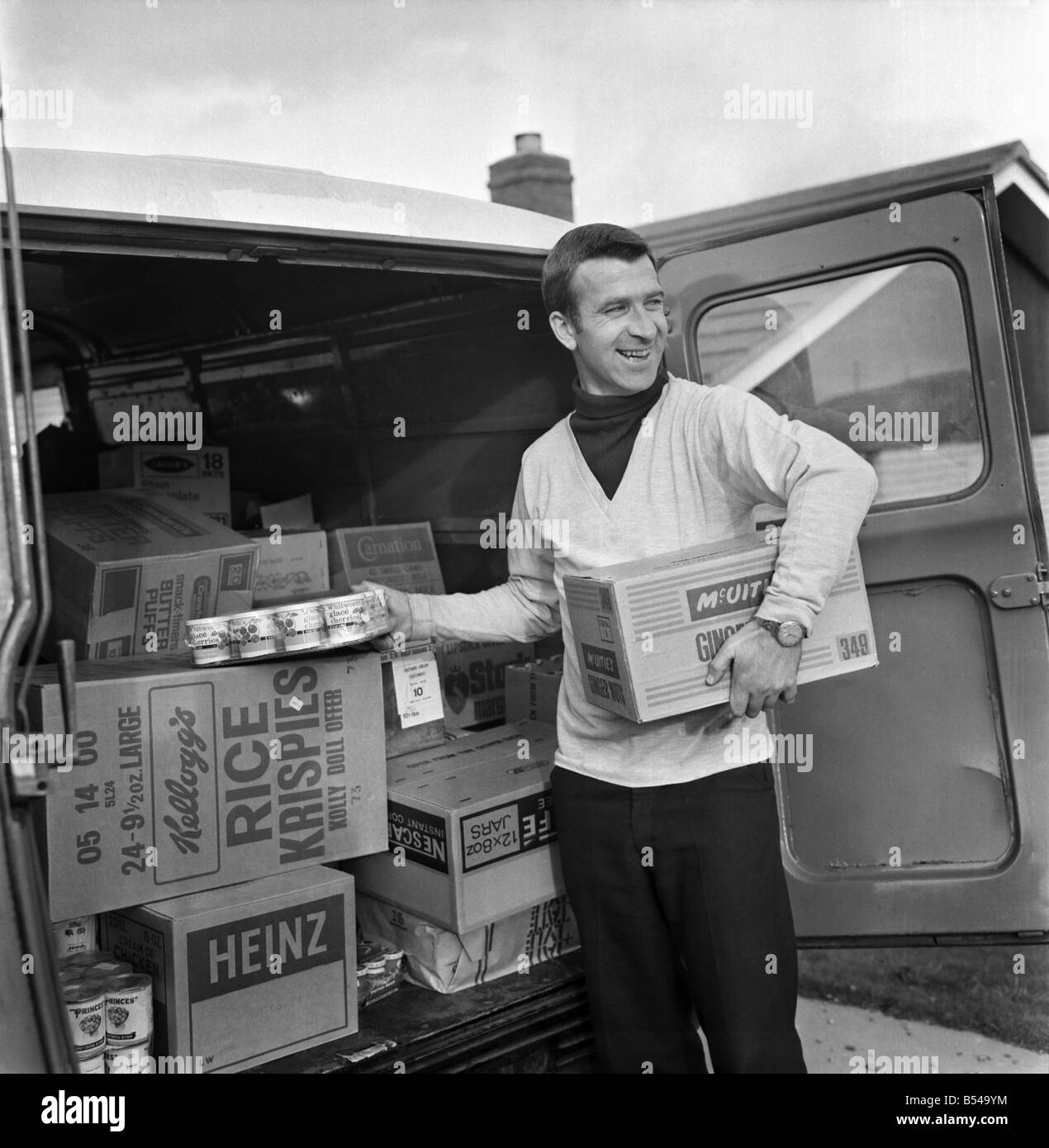 Ex Blackburn and England winger Bryan Douglas loading his grocery van ready for a day on the market. Since retiring from first class football Bryan sells on Clitheroe market two days per week. ;November 1969 ;Z10745-002 Stock Photo