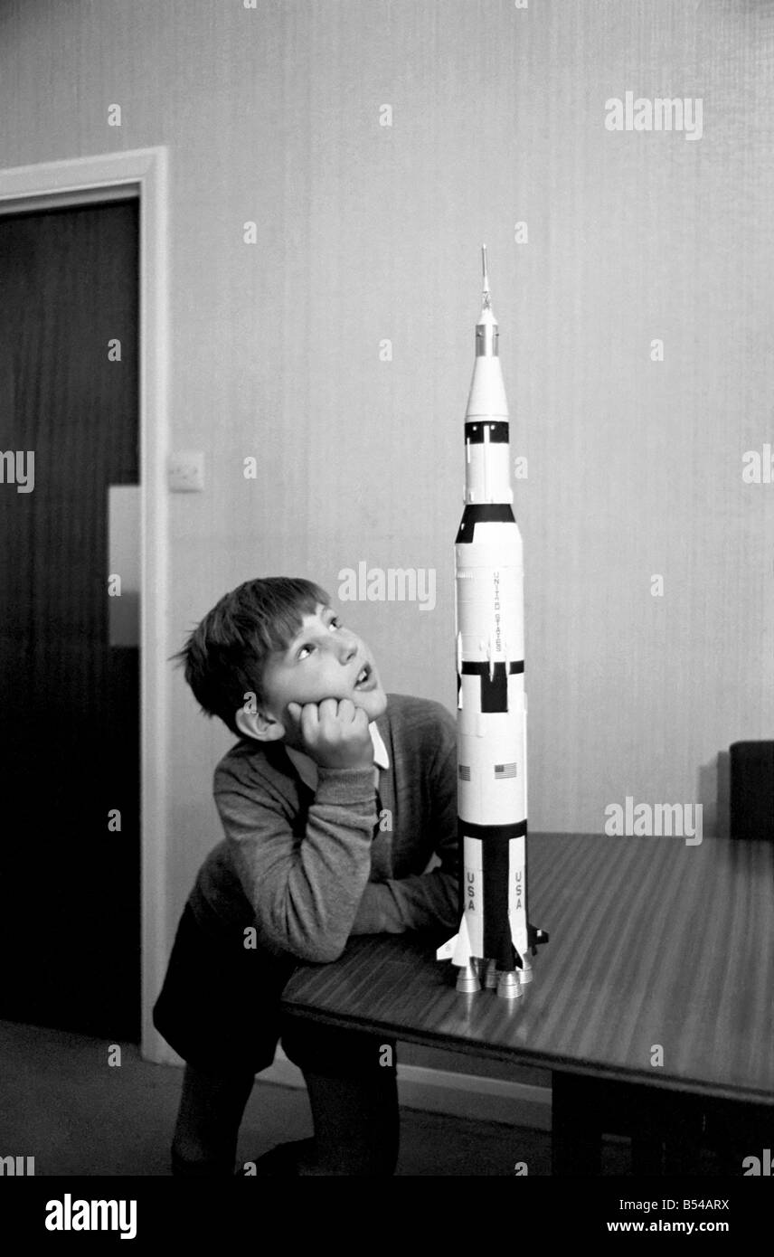 Apollo 12 moon rocket model on display. ;Paul Ward 8 of Belgravia studies the Apollo model. November 1969 ;Z10880-003 Stock Photo