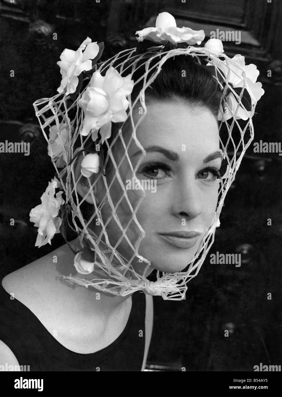 Simone Mirman today showed her spring and summer collection for 1964 at Chesham Place, London. ;Caroline Dalgety in a kerchief of camelias. ;March 1964 ;P017013 Stock Photo