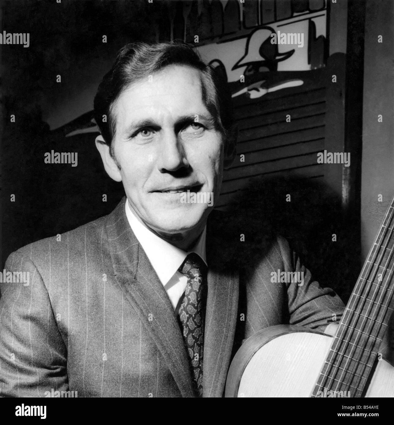 Chester Burton Chet'' Atkins with a guitar he brought with him to present the Nashville Room. ;March 1969 ;P017016' Stock Photo