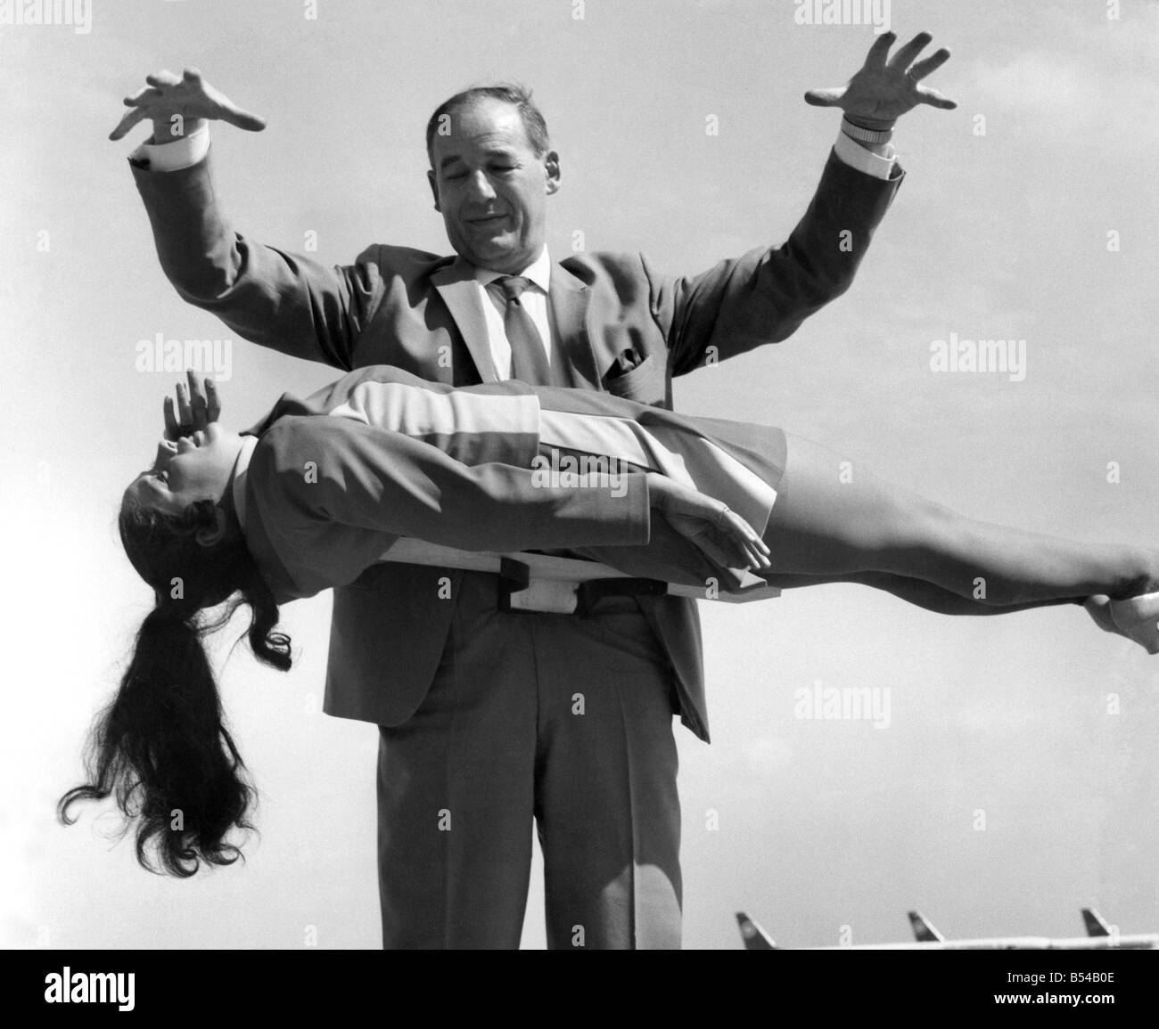 Mr. Jeffrey Atkins, before he flew performed a trick with Air Hostess Jacquie Moore (20) from Hanworth. June 1971 Stock Photo