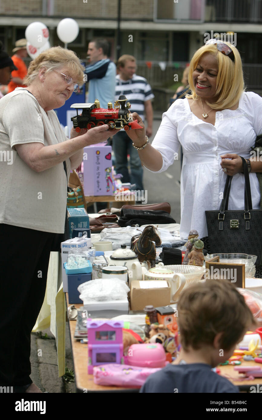 Two women look at a model train on a white elephant stall at a fete in Bristol. Stock Photo