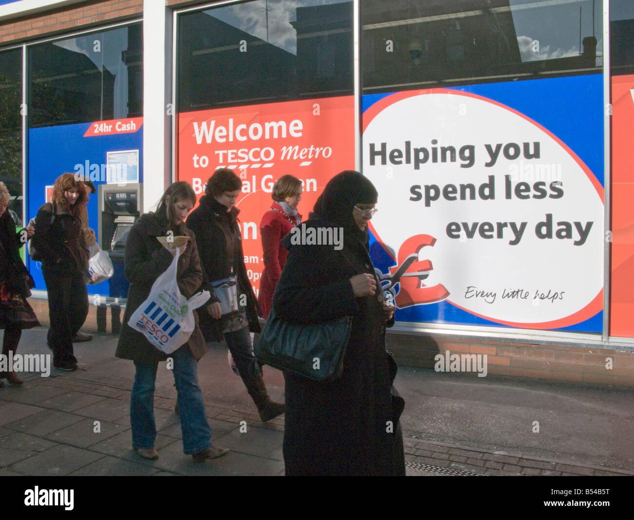 UKLocals walking past a Tesco supermarket in Bethnal Green Rd, London