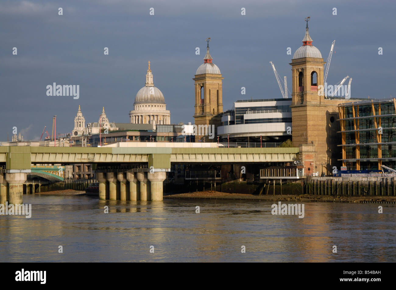 City Spires: Spires of St Paul's Cathedral and Cannon Street Station and Railway Bridge above River Thames, City of London Stock Photo