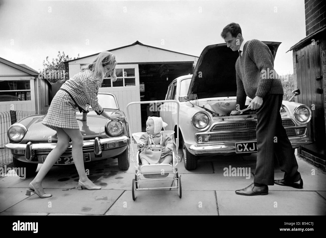 Models pose for a Lolly Dolly wives feature in Manchester. Man and woman and child in a suburban neighbourhood. Nov. 1969 Stock Photo