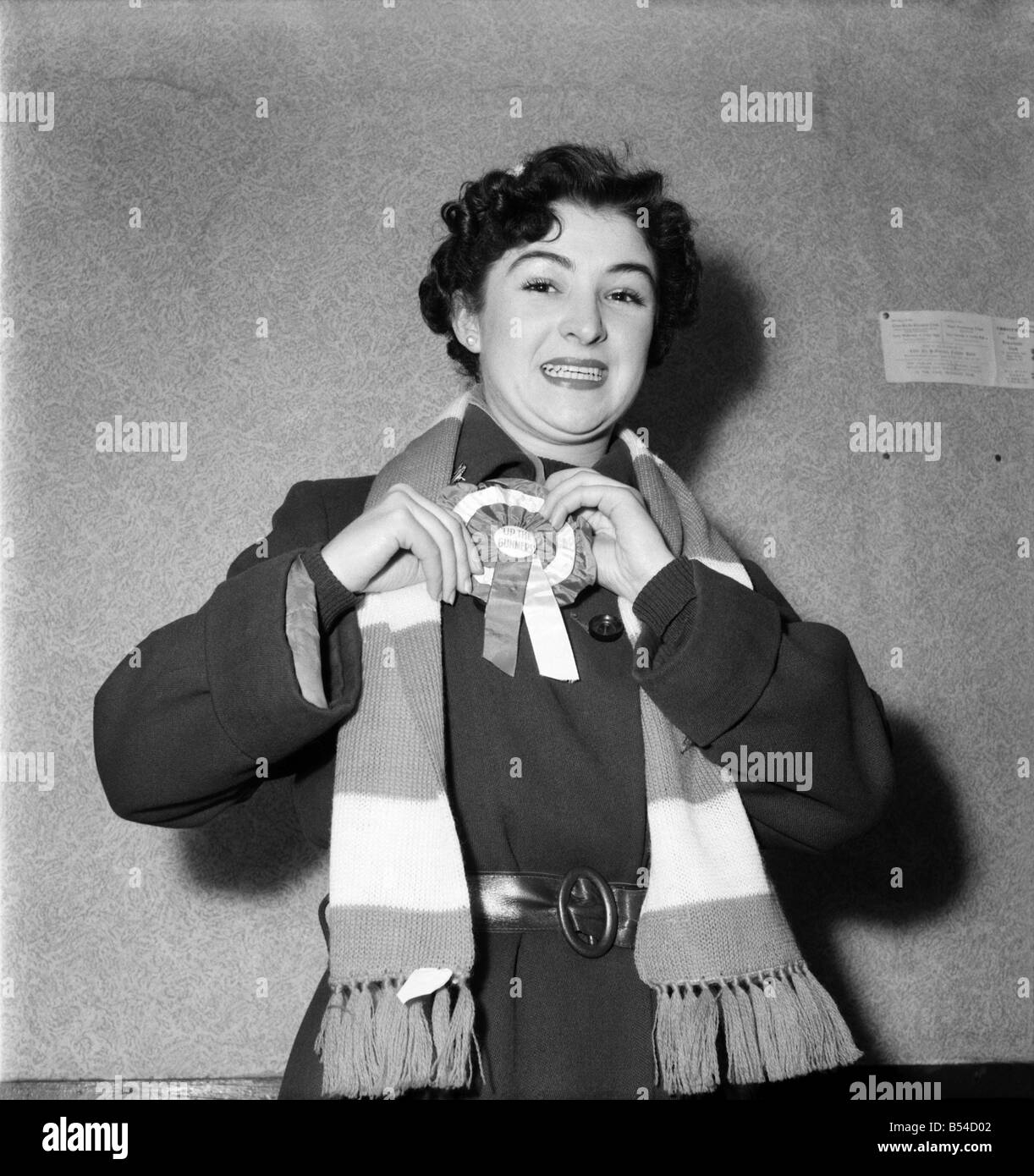 A female Arsenal fan showing of her rosette and scarf. February 1953 &#13;&#10;D697 Stock Photo