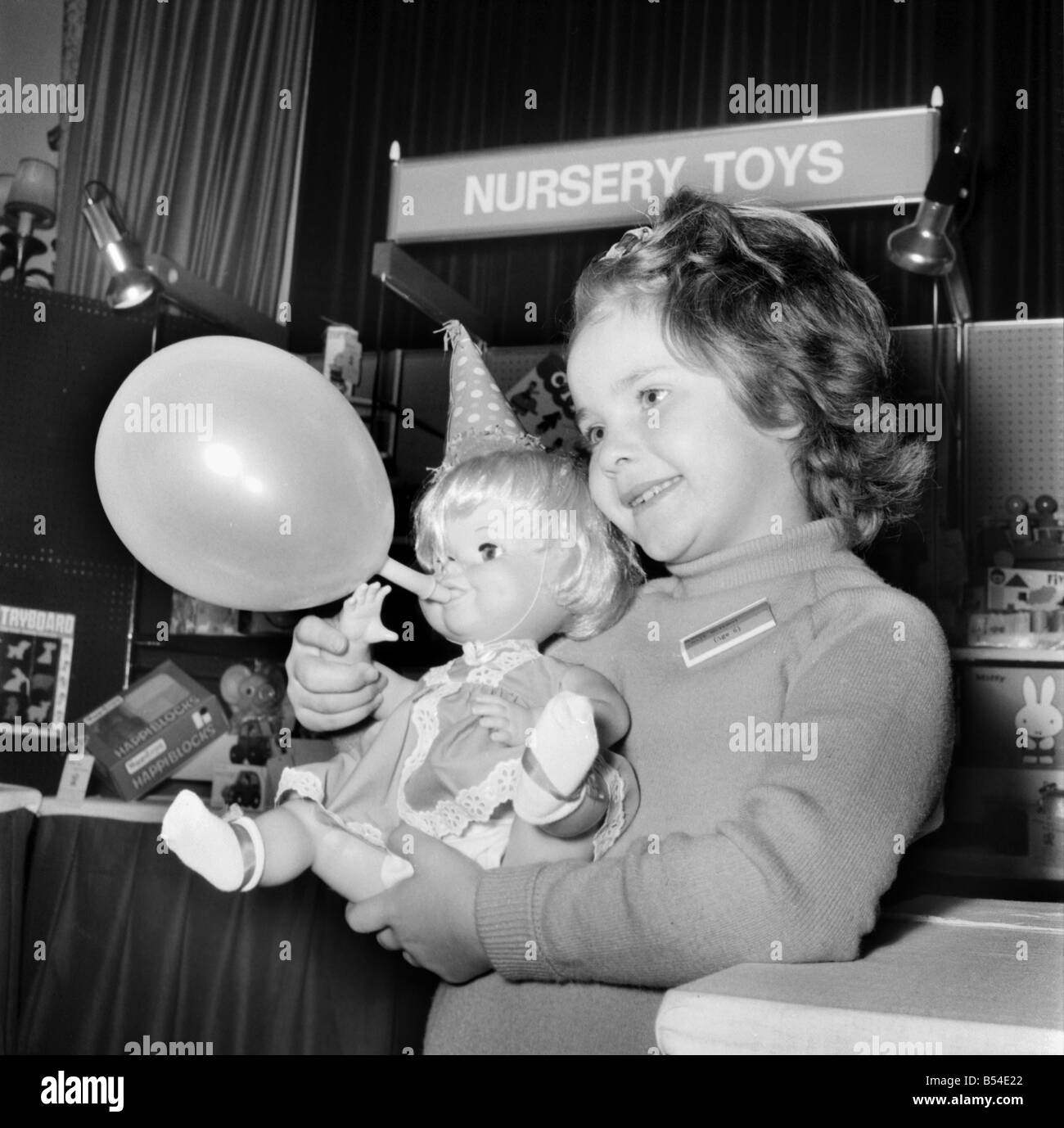 Children. Toys: The British Toy Manufacturers Association held a pre-Christmas display of new British Toys at the Waldorf Hotel, W.C.2. Holding the latest design in dolls - one which will blow up a balloon when its arms are moved is 6 year old Gail McIlroy of Wallington, Surrey. November 1969 Z10631-003 Stock Photo