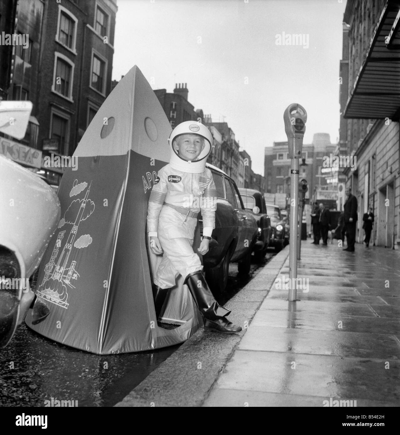 Children. Toys: The British Toy Manufacturers Association held a pre-Christmas display of new British Toys at the Waldorf Hotel, W.C.2. Up to the minute toy for young space travellers is this space-suit and Apollo Playhouse made by D.Dekker. 7year old Stephen Taylor of Chertsey tried the new space gear but appeared to have a little problem with parking his rocket in the street outside the hotel. November 1969 Z10631-006 Stock Photo