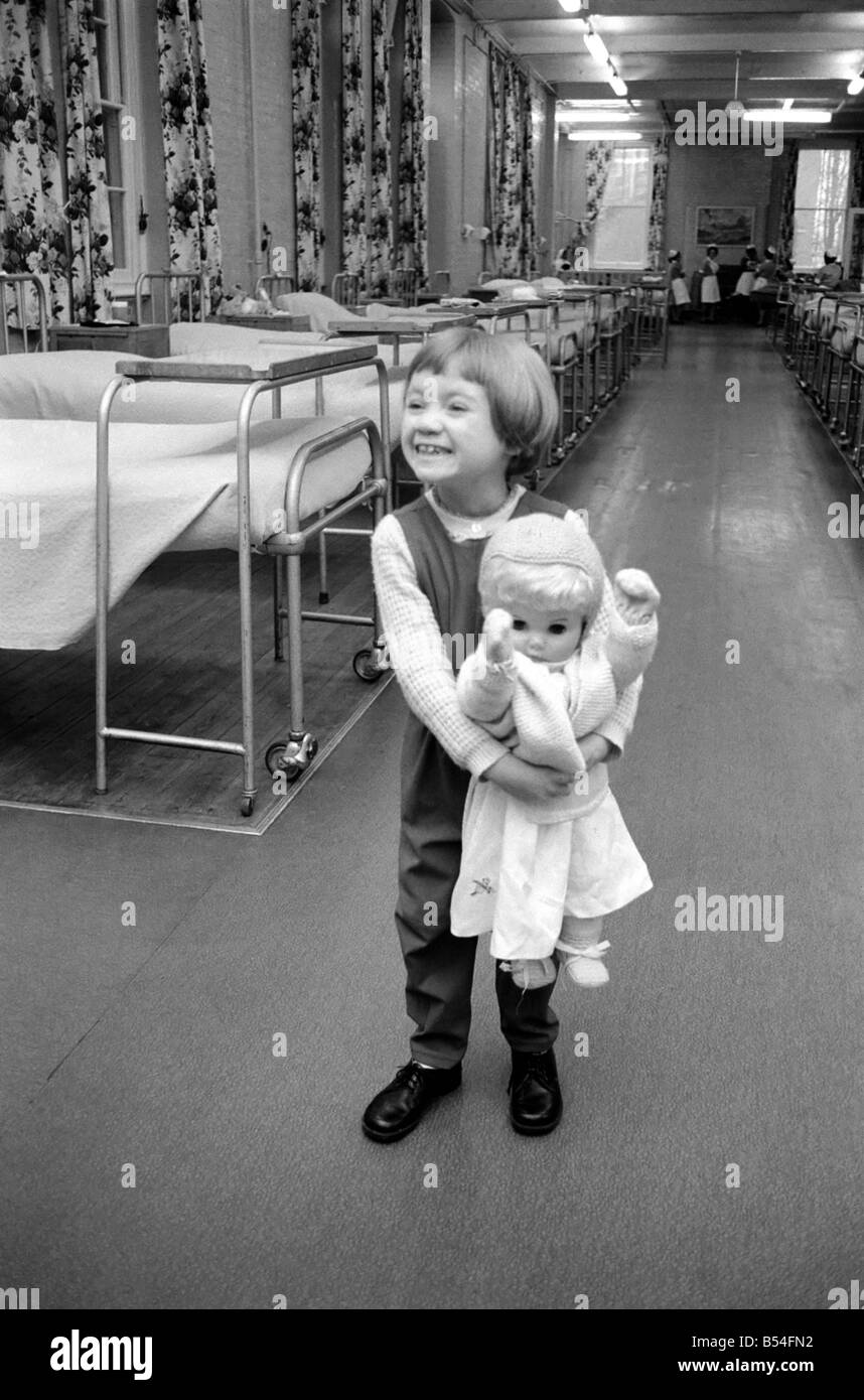 A young girl in hospital with her toy doll. December 1969 Z11518 Stock Photo