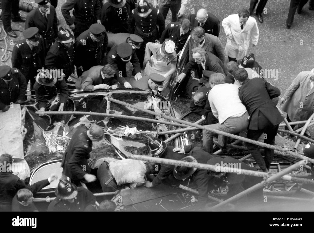 Police and fireman swarm at the scene where a 100ft framework of Scaffolding collapsed on to a Daimler limousine, killing Sir David Rose, Governor General of Guyana. ;November 1969 ;Z10837 Stock Photo