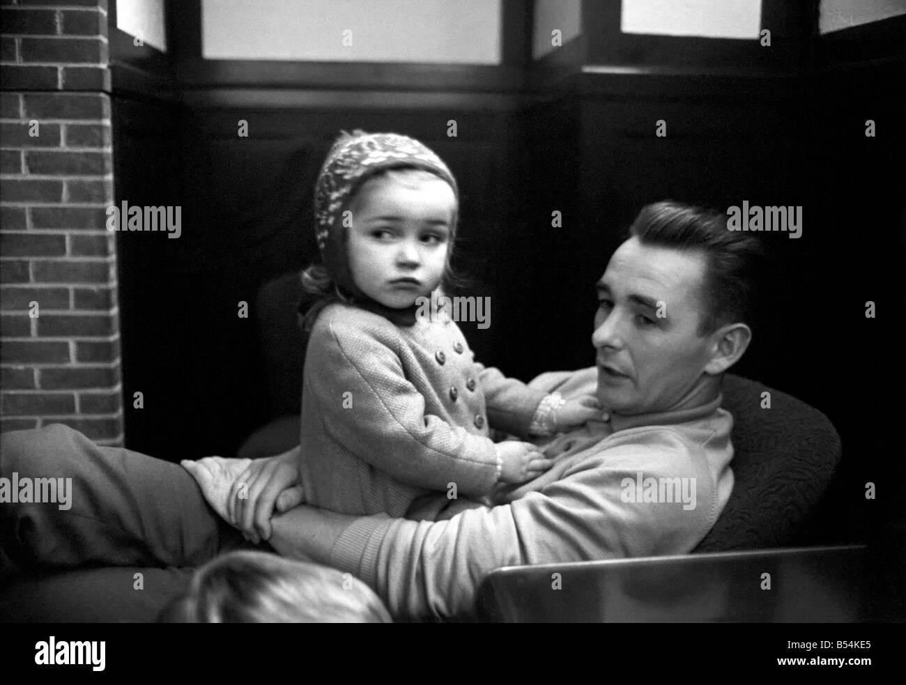 Sport: Football: Derby manager Brian Clough ponders the league cup draw the morning after his team's success at the baseball ground against Crystal Palace. Brian Clough with his two year old daughter Elizabeth watched by his son. October 1969 Z10423-003 Stock Photo