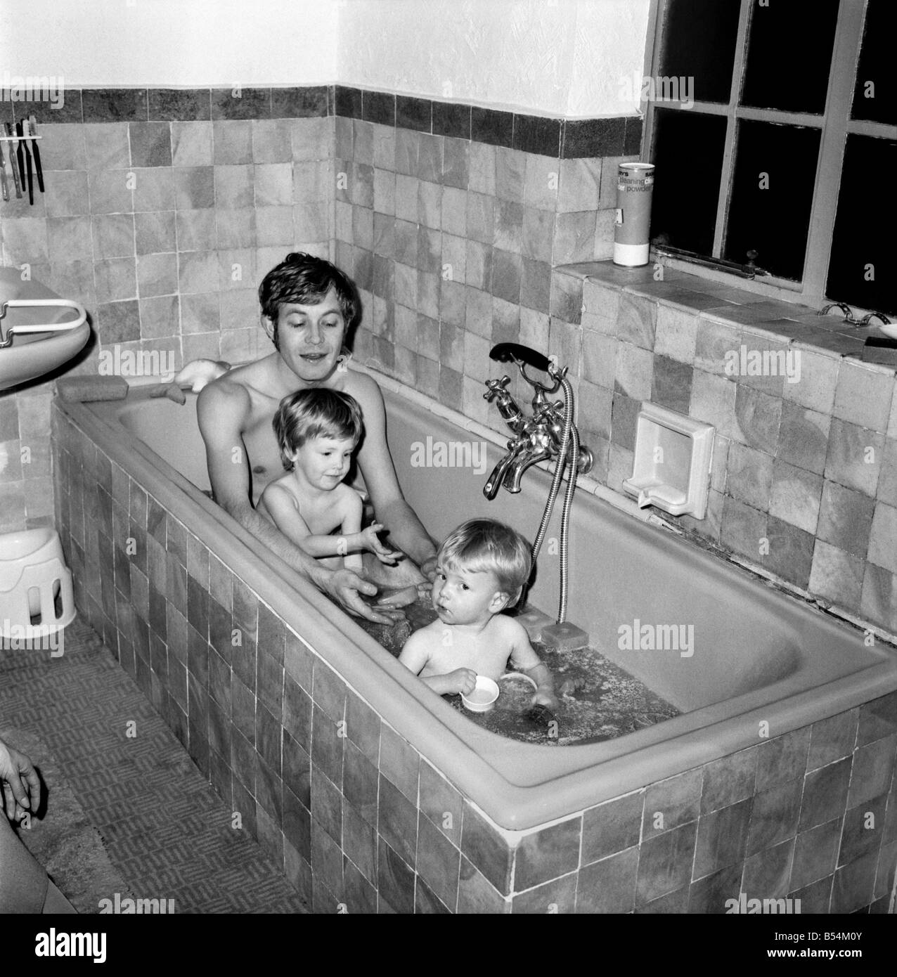 Families Mother, father and children. Father in the bath with baby boy