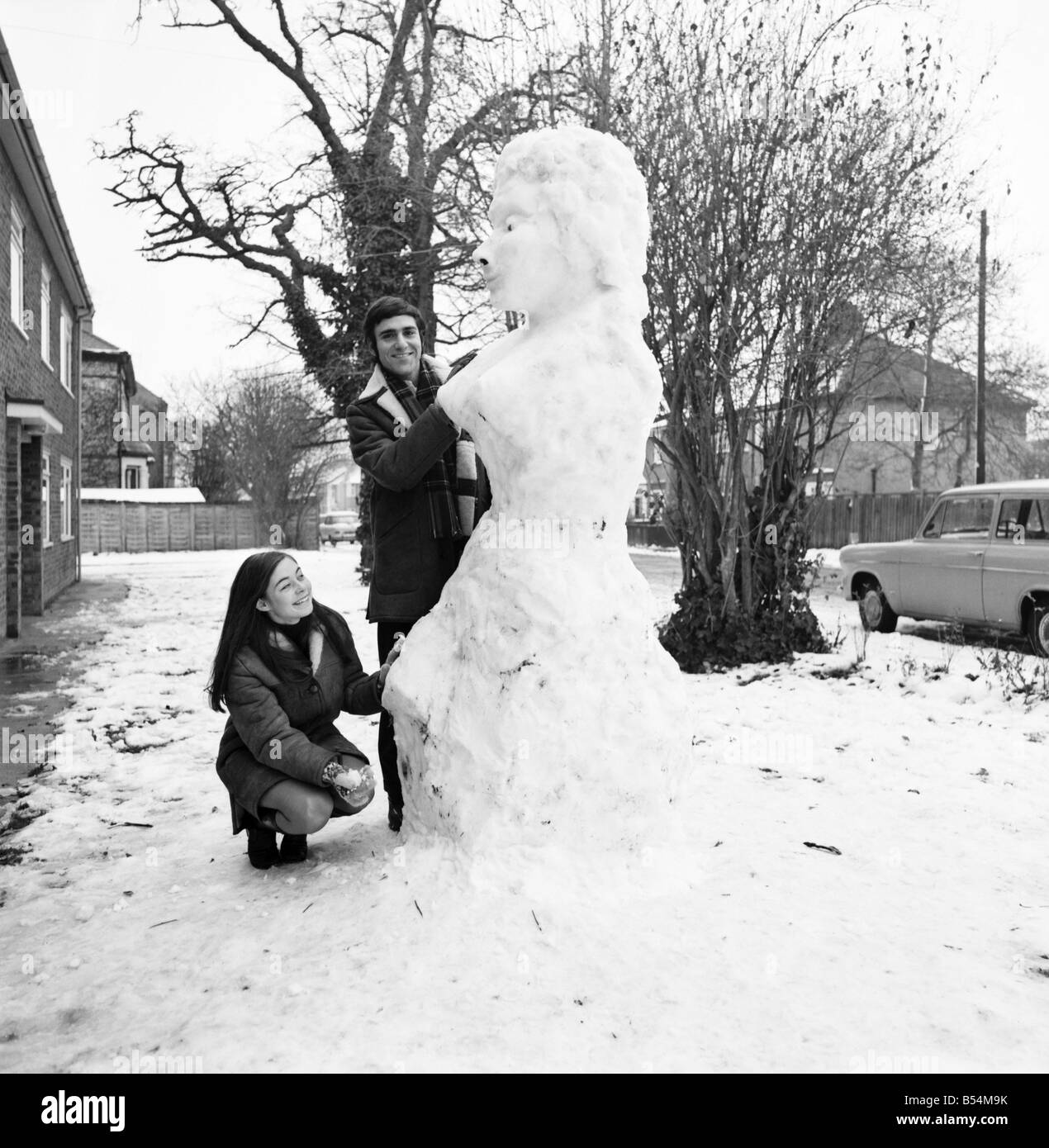 American graduate student, Ken Donney (23) and wife Jill ((20) seen with the snow woman they built from the first snow they have ever seen fall. Snow-woman's vital statistics - 78, 51, 108. ;December 1969 ;Z11507 Stock Photo