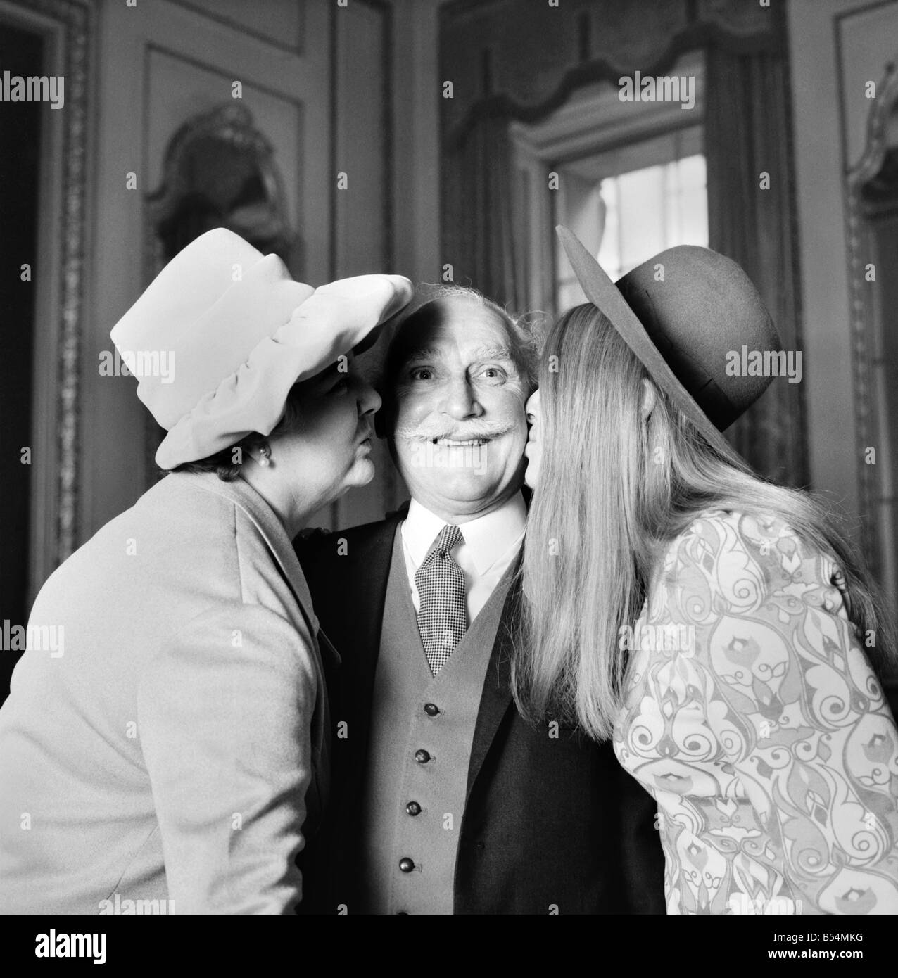 The Lord Mayor, Sir Ian Bowater today presented the Binney Memorial Awards for bravery by civilians, at the 'Goldsmiths' Hall in City of London. Mr. Trevelyan H. Cowling gets a kiss from his wife Kathleen on left and 21 year old daughter Elizabeth. December 1969 Z11552-001 Stock Photo