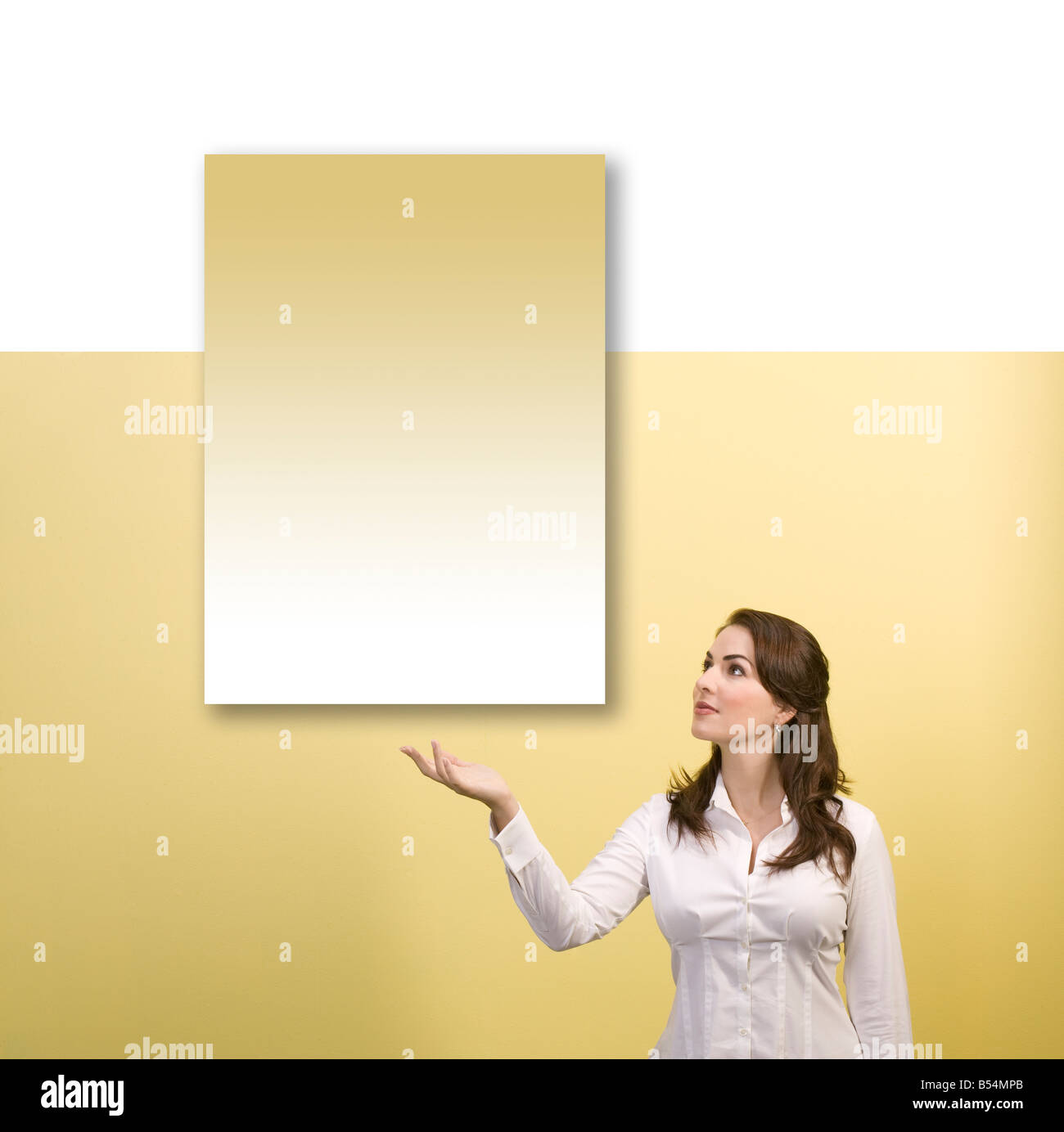woman displays empty floating sign yellow and white Stock Photo