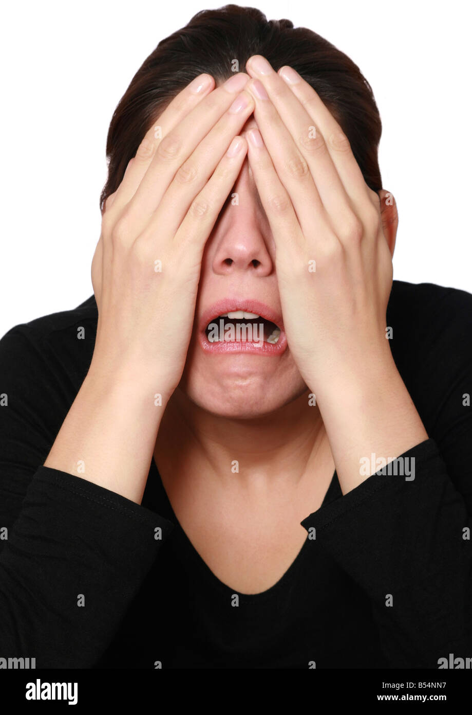 frightened woman covering her eyes Stock Photo
