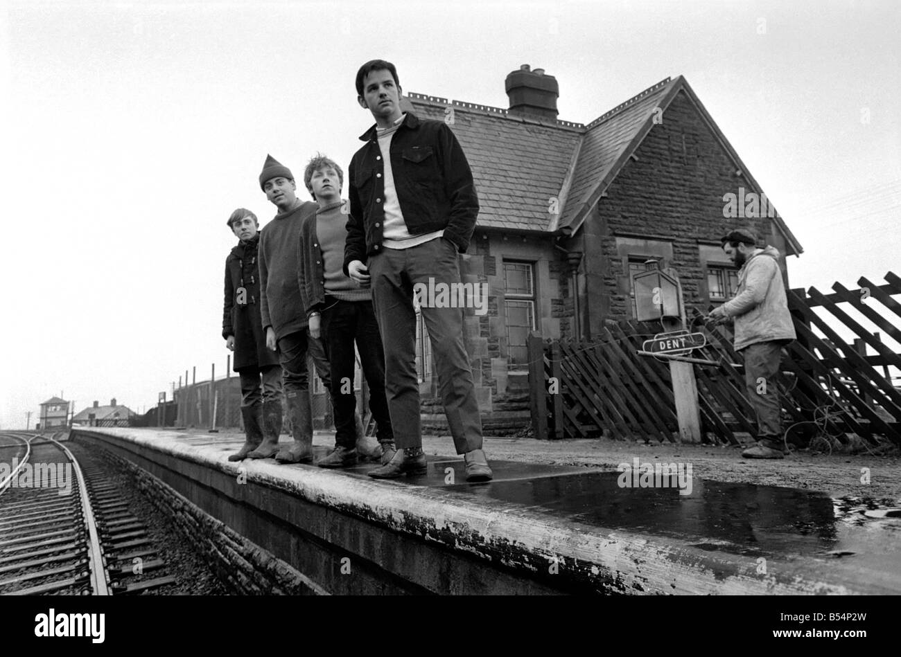 Transport. Rail. Funds raised by selling knickers and bras has helped schoolboys to acquire their own railway station. Boys from the Barden Country Sec School, Burnley, Lancs are now spending their spare time renovating and converting the station at Dent, near Sedbergh. Geoffrey Heys (14), John Loughling (14), Anthony Jordan (14) and Lewis Welsh. (Master at right is Mr Alan Binns) watching out for a train St Dent Station. December 1967 Z11821-002 Stock Photo