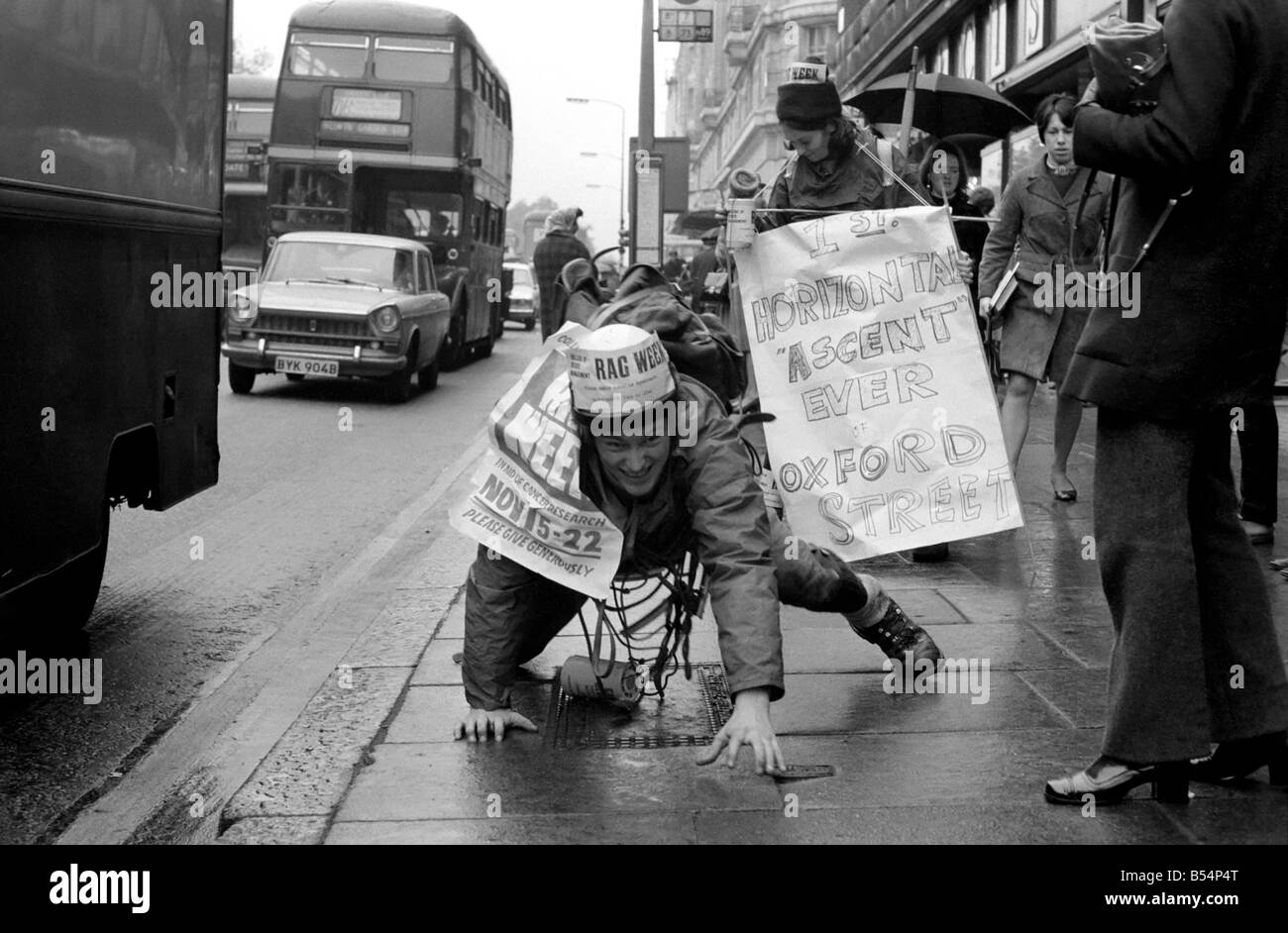 One of the six student mountaineers making a horizontal attempt on Oxford Street today, was John Phipps who comes from the College of Estate Management, Kensington. He inched his way from Marble Arch using cracks between paving stones to pull himself along - all in aid of the Cancer Research charity. John Phipps doing his climb up the Pavement November 1969 Z11239-002 Stock Photo