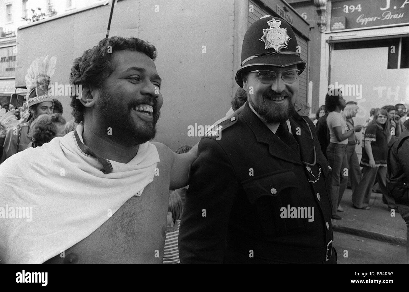 Notting Hill Carnival August 1977 A man laughs and jokes with a police ...
