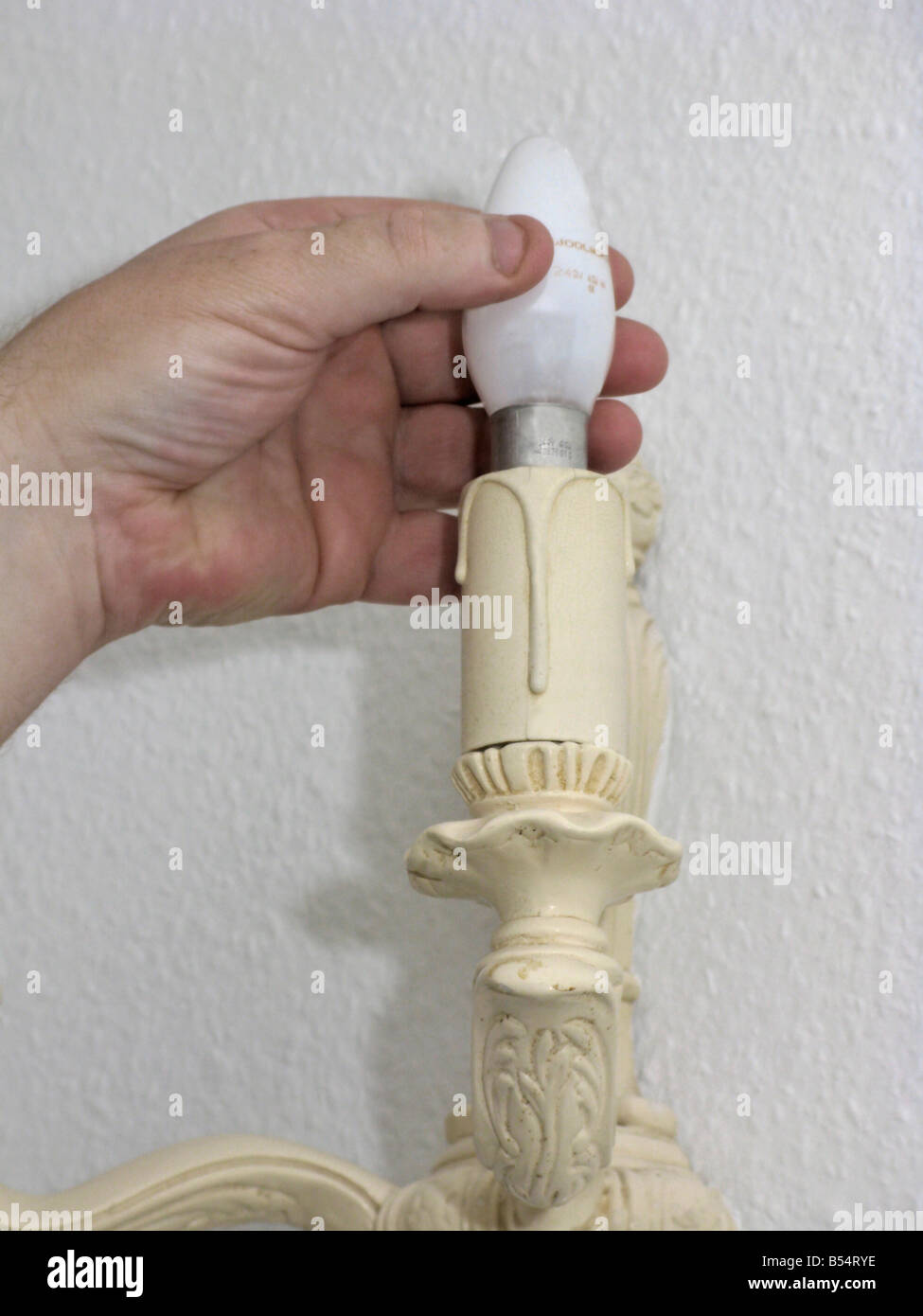 man fitting an energy efficient saving light bulb Stock Photo - Alamy