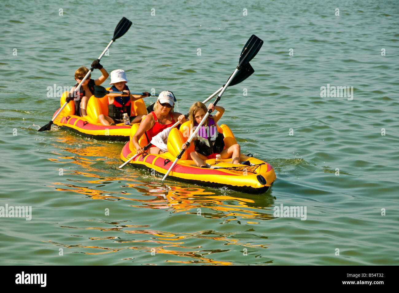 family inflatable PVC yellow kayaks summer vacations kayaking racing Stock Photo