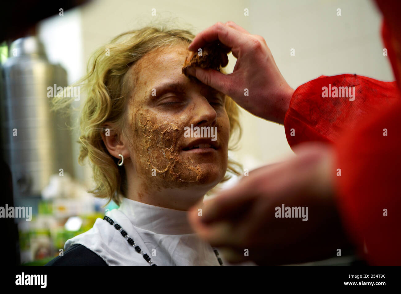 A woman has make up applied which transforms her into a zombie Stock Photo