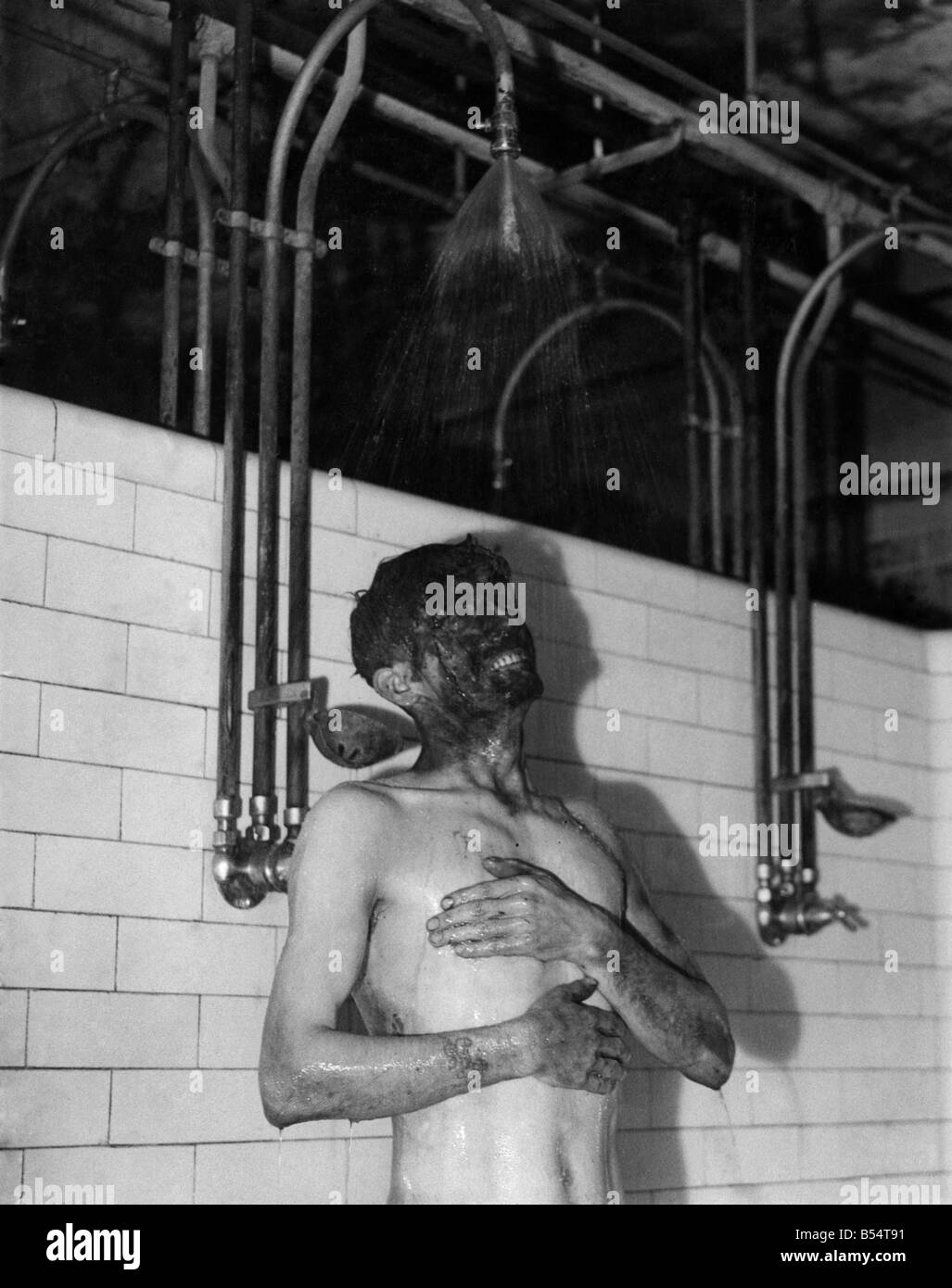 There's plenty of hot water on top, and this 'Happy Pit' miner is making good use of it. &#13;&#10;March 1947 &#13;&#10;P011972 Stock Photo