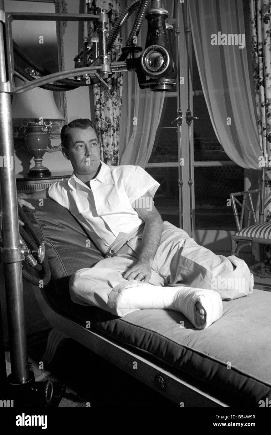 Film star Alan Ladd, who has injured his foot. October 1953 D6473-002 Stock Photo