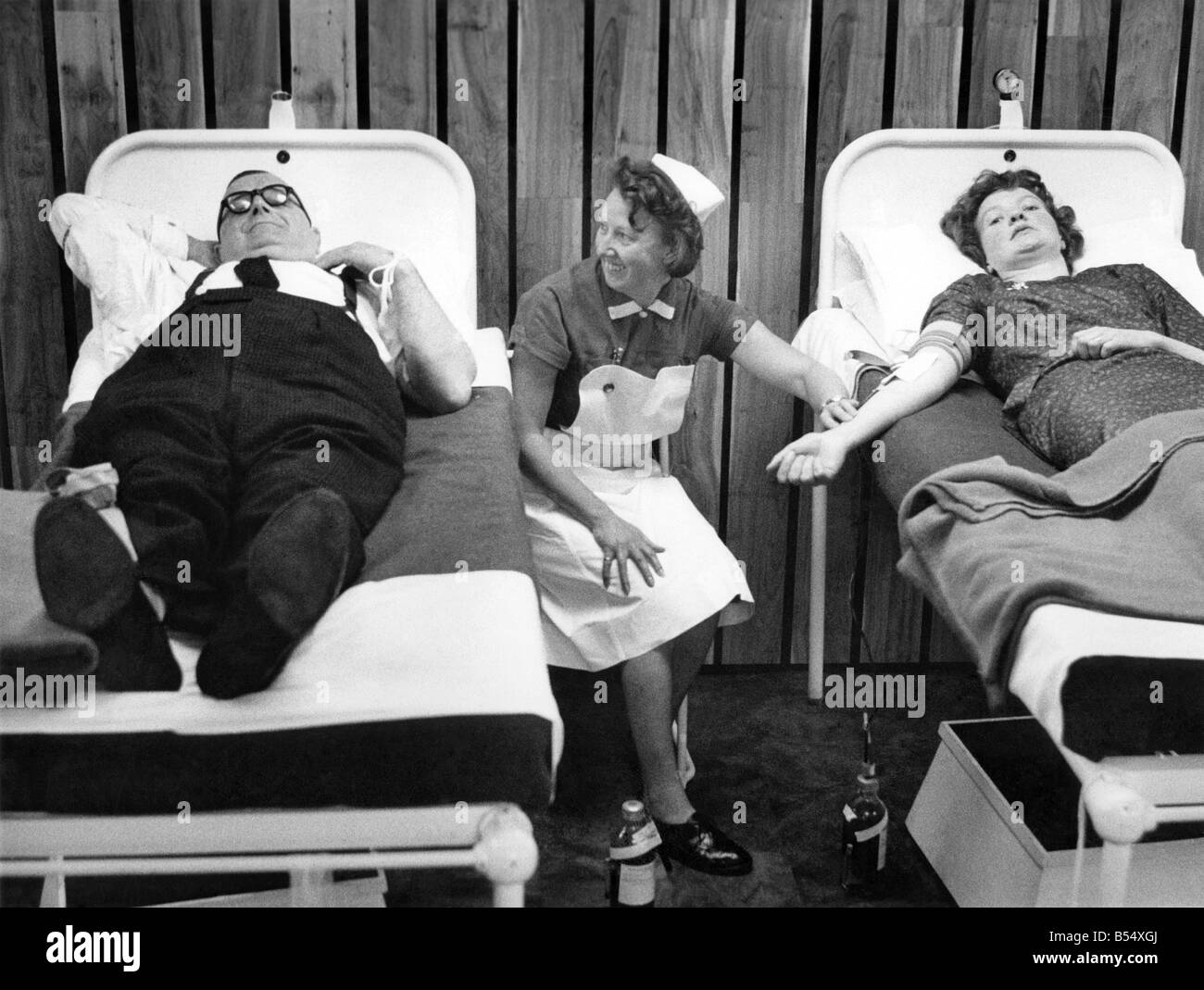 Blood Donors. Mr. Sydney Spencer (59) of Thursby Rd., Burnley and Mrs Ann Piper (25) of Paddock Lane, Kettle Shumle, Whalley Bridge, donating blood at the Blood Bank, Manchester, after they had received an urgent request from Denmark. P011350 Stock Photo