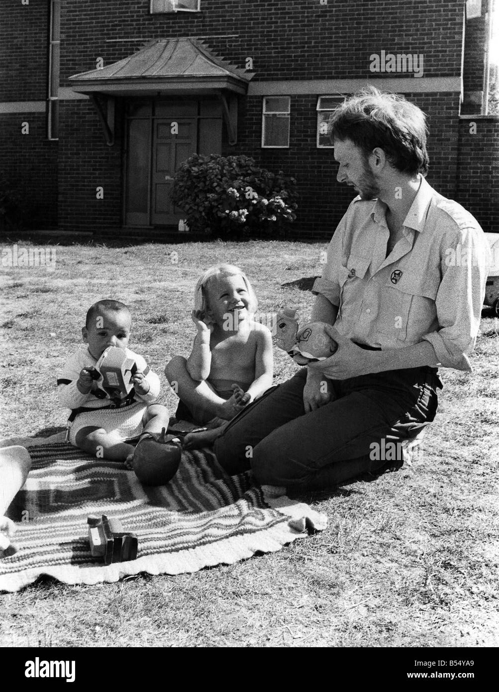 23-year-old Gary Chaplin is a play group leader at Battersea's Patmore Play Group in London. He gets immense satisfaction from his work. He loves children and they all love him. ;October 1979 ;P012127 Stock Photo