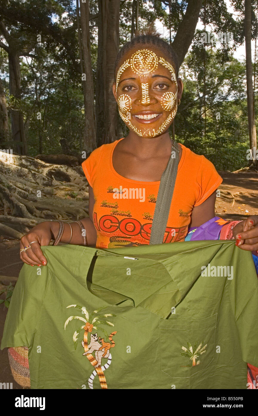 AFRICA MADAGASCAR Nosy Be young girl with decorated face selling cloth