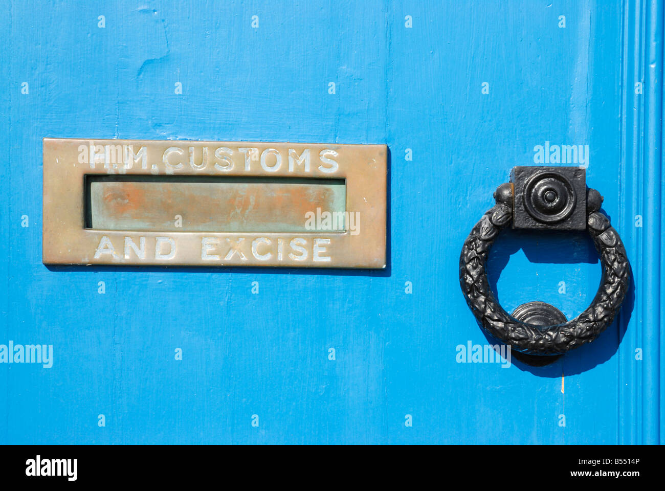 Exeter, Devon, UK. Letterbox and knocker on the door of the Custom House on Exeter Quay. Words