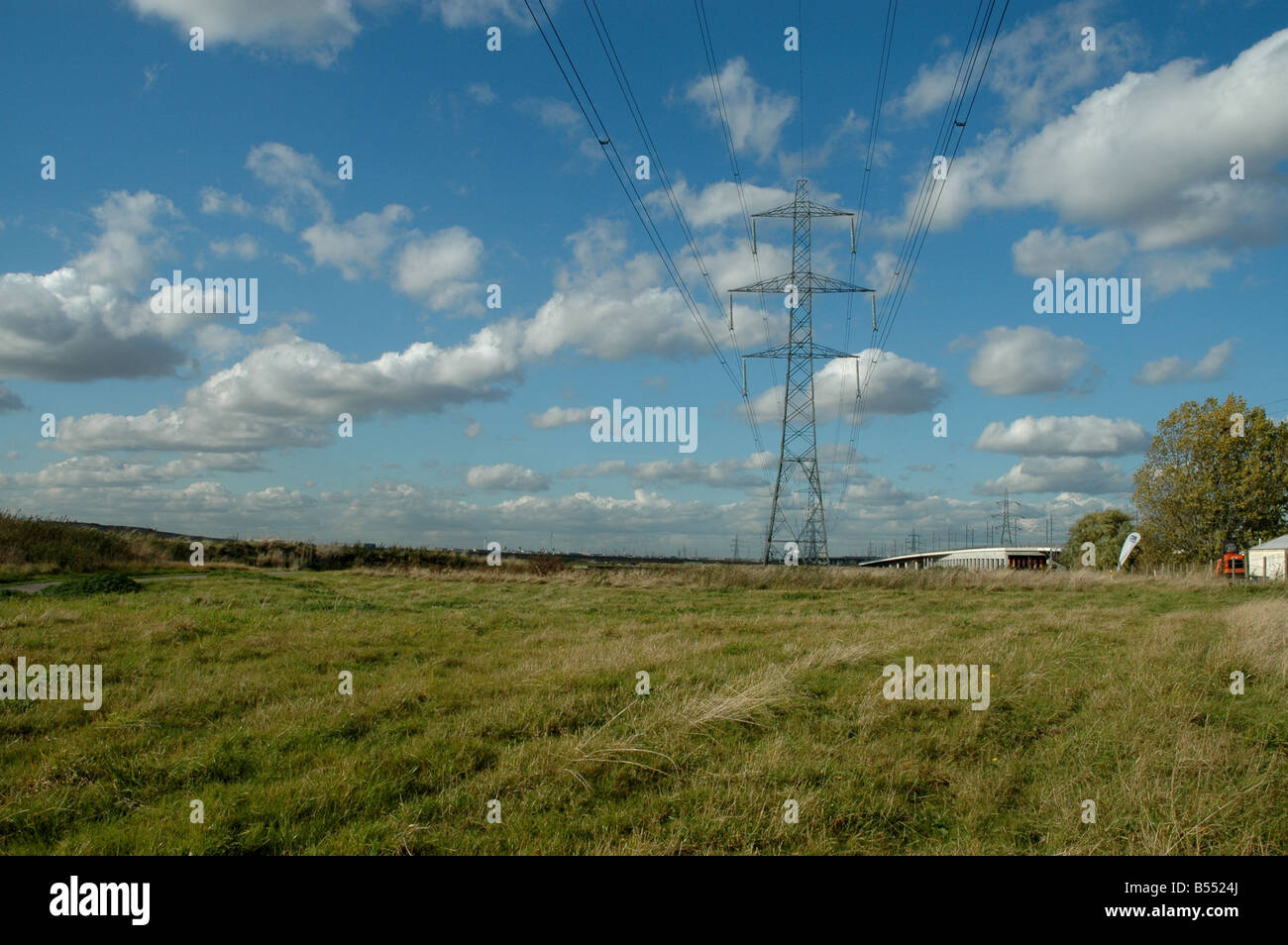 An electricity pylon with blue sky above Stock Photo
