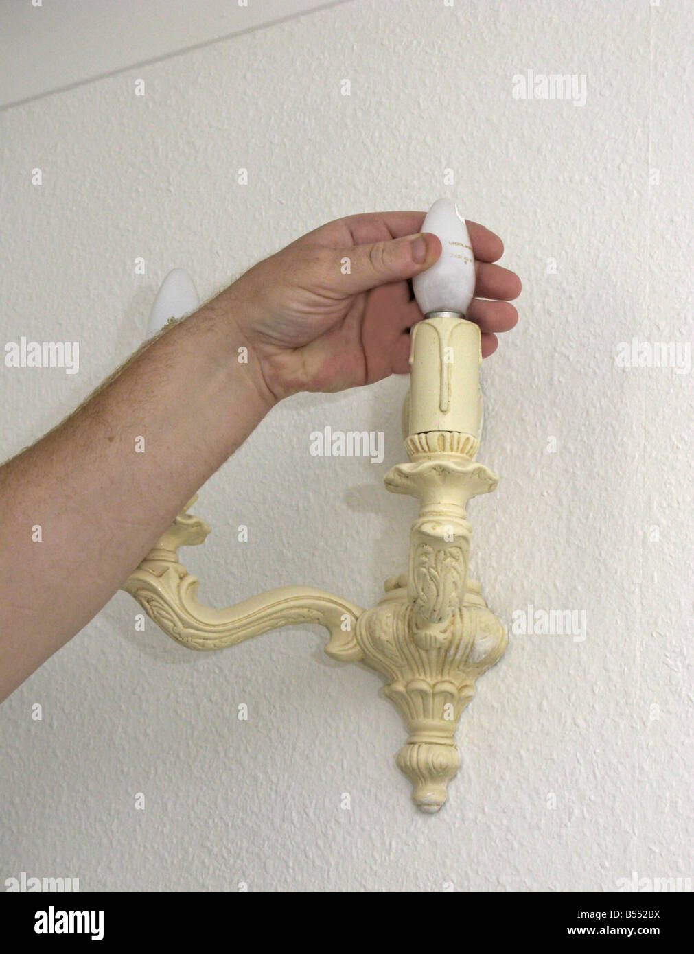 man fitting an energy efficient saving light bulb Stock Photo - Alamy